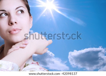 Portrait of the young brunette on a background of the sky with the shining sun. - stock-photo-portrait-of-the-young-brunette-on-a-background-of-the-sky-with-the-shining-sun-42098137