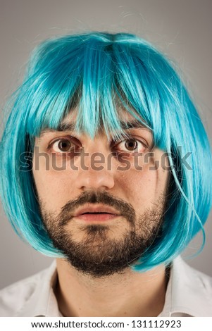 stock-photo-funny-bearded-man-with-a-blue-wig-on-grey-background-131112923.jpg