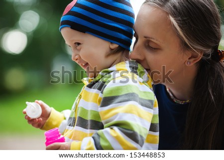A young mother and her baby fall fun - stock photo