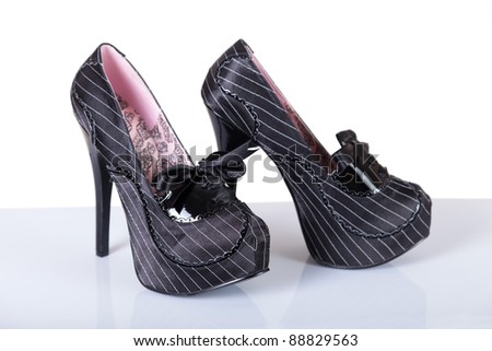 Gangster style modern female shoes, studio shot on white background