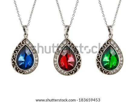 Three vintage silver drop shaped pendants with gemstones on white ...