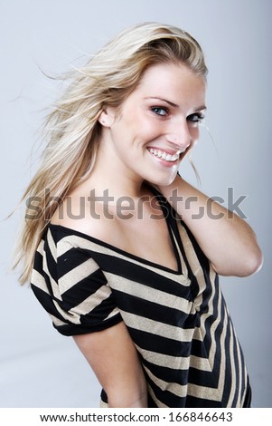 http://thumb101.shutterstock.com/display_pic_with_logo/1528718/166846643/stock-photo-elegant-woman-with-a-beautiful-smile-and-her-long-blond-hair-blowing-in-the-breeze-wearing-a-166846643.jpg