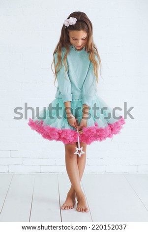 stock-photo-studio-portrait-of-cute-little-princess-girl-wearing-holiday-candy-tutu-skirt-holding-magic-wand-220152037.jpg