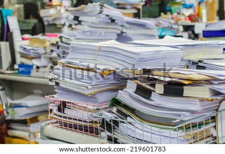 stock-photo-pile-of-documents-on-desk-st