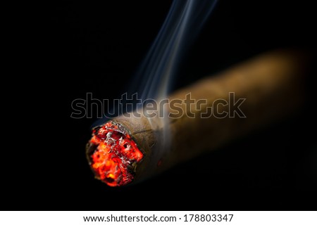 stock-photo-burning-cigar-on-black-background-178803347.jpg