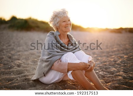 http://thumb101.shutterstock.com/display_pic_with_logo/163108/192317513/stock-photo-happy-retired-woman-wearing-shawl-sitting-relaxed-on-sand-at-the-beach-senior-caucasian-woman-192317513.jpg