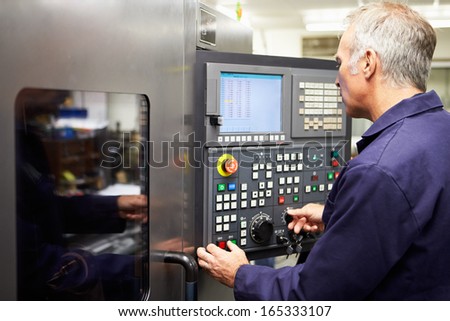 Engineer Operating Computer Controlled Lathe - stock photo