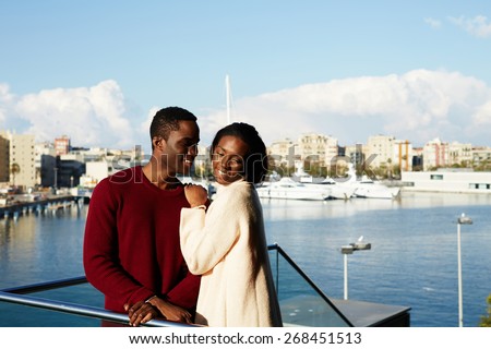 stock photo portrait of happy hugging couple on modern balcony with beautiful port with yachts on background 268451513
