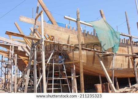  Oman, October 23, 2013: Man at work building a boat. Boat in Oman
