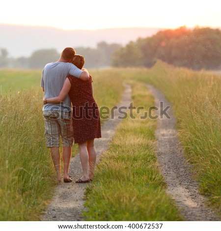 http://thumb101.shutterstock.com/display_pic_with_logo/2500636/400672537/stock-photo-couple-in-love-walking-together-endearing-couple-in-love-taking-a-walk-along-a-road-through-the-400672537.jpg