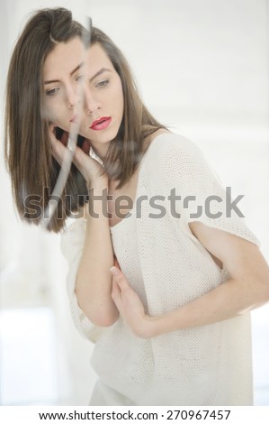 http://thumb101.shutterstock.com/display_pic_with_logo/2813080/270967457/stock-photo-androgynous-beautiful-young-man-like-a-beautiful-woman-with-red-lipstick-looks-in-a-broken-mirror-270967457.jpg