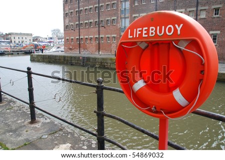 orange buoy foam lifesaving ring at Gloucester docks in England, UK 