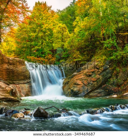 stock-photo-falling-a-beautiful-waterfall-in-autumn-colors-basca-chiojdului-river-siriu-mountains-basca-349469687.jpg