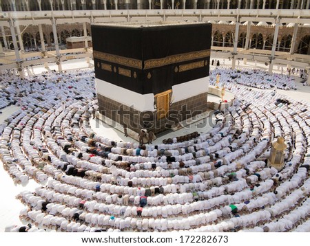 Kaaba the Holy mosque in Mecca with Muslim people pilgrims of Hajj praying in crowd (newest and very rare images of Holiest mosque after latest widening 2013-3014) - stock photo