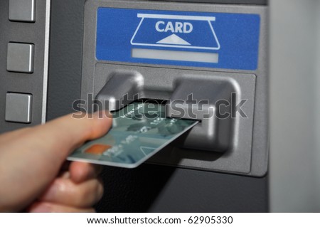 Withdraw money from ATM machine - stock photo