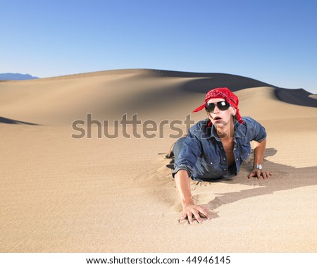 stock-photo-young-man-in-sunglasses-wearing-red-bandana-crawling-in-sand-horizontal-shot-44946145.jpg