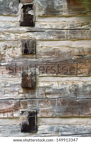 Rough cut wooden timbers in a pioneer home are photographed close 