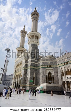 MECCA, SAUDI ARABIA-CIRCA MAY 2015: Muslims get ready to pray and enter the mosque using King Al Fahad Gate of Masjidil Al Haram on MAY,2015 in Mecca, Saudi Arabia.  - stock photo