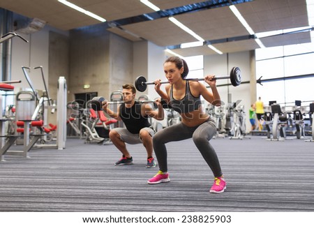 stock-photo-sport-bodybuilding-lifestyle-and-people-concept-young-man-and-woman-with-barbell-flexing-238825903.jpg