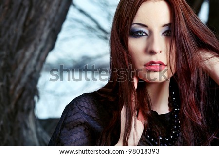 stock-photo-shot-of-a-gothic-woman-in-a-winter-park-fashion-98018393.jpg