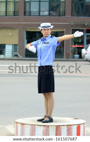 http://thumb101.shutterstock.com/display_pic_with_logo/694342/161507687/stock-photo-luannan-county-september-female-traffic-police-were-directing-traffic-in-the-street-on-161507687.jpg