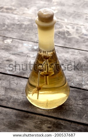 Glass bottle of homemade traditional drink Rakia on the wooden table 