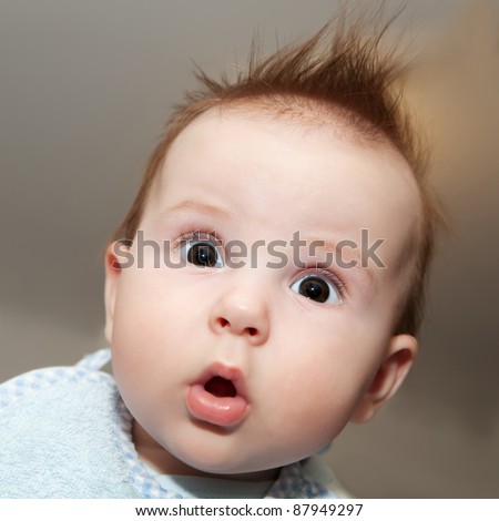 Cute 4 months old baby making a funny surprised face - stock photo