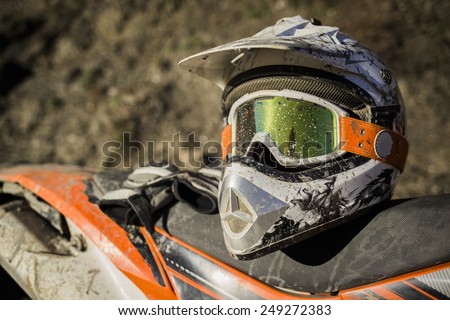 Dirty motorcycle motocross helmet with goggles  stock photo