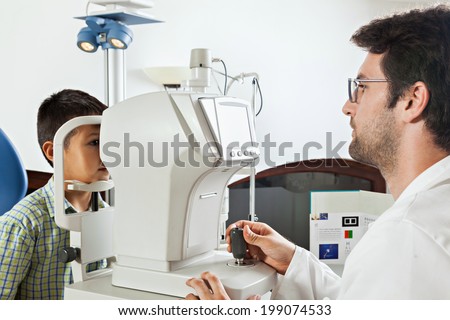 stock-photo-ophthalmologist-in-exam-room-with-little-boy-sitting-in-chair-looking-into-eye-test-machine-199074533.jpg