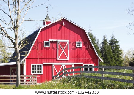 bright red barn stands in the mid-day sun/Bright Red, Barn/A red 