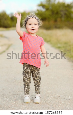 stock-photo-baby-girl-waving-her-hand-sa