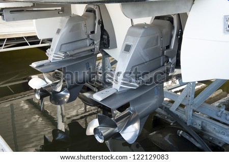  pleasure boat safely stored on a hyrdolic lift in a dock - stock photo