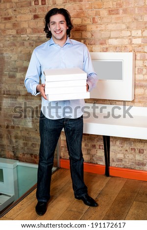 stock-photo-young-cheerful-man-holding-a-stack-of-pizza-boxes-191172617.jpg