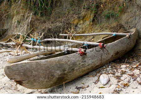 stock-photo-traditional-dugout-outrigger-canoe-on-a-beach-on-tanna-island-vanuatu-215948683.jpg