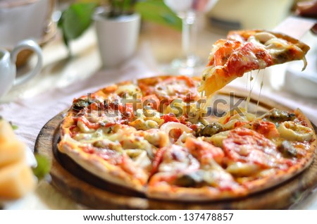 Seafood Italian Pizza slice on wood dish (originality) - stock photo