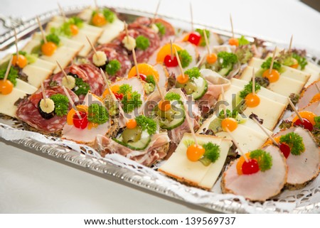 Appetizers on a tablet served by a caterer in a restaurant or hotel - stock photo