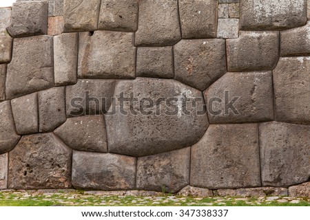 Ancient and mysterious stone wall in Sacsayhuaman Inca archaeological site in Cusco, Peru - stock photo