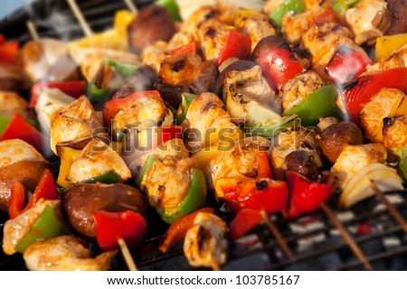 Bar-B-Q or BBQ with kebab cooking. coal grill of chicken meat skewers with mushroom and peppers. barbecuing dinner - stock photo