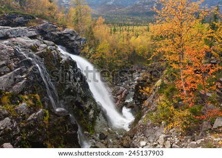 Risjok waterfall on freshwater stream going into autumn taiga forest ...