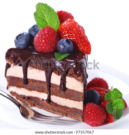 Piece of chocolate cake with icing and fresh berry on white isolated background - stock photo