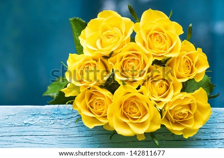Yellow Roses Bouquet on the blue wood - stock photo
