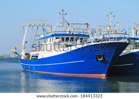 Modern steel fishing ships docked in port - stock photo