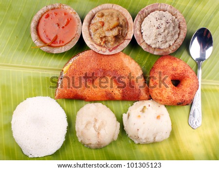 Traditional south indian breakfast with dosa, idly, vada, upma, kesaribath with spicy indian curry and chutney - stock photo