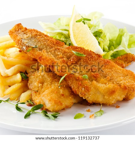 Fish dish - fried fish fillet with vegetables on white background - stock photo