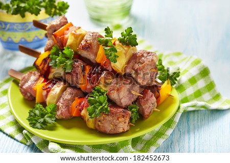 Delicious pork kebab with vegetables and bacon - stock photo