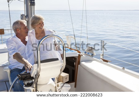 stock photo a happy senior couple sailing and sitting at the wheel of a sail boat on a calm blue sea 222008623